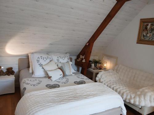 a bedroom with a bed and a couch at La parenthèse bucolique in Sepmes