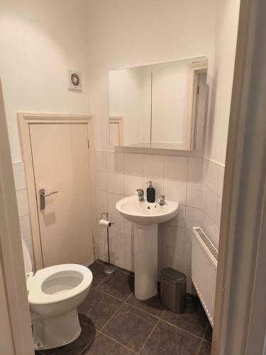 a bathroom with a white toilet and a sink at Connell Court in London