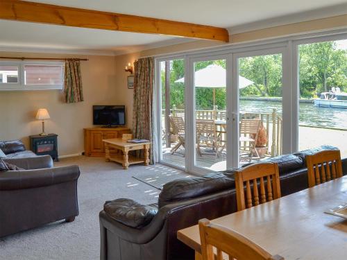 a living room with a couch and a table at Watersedge - E1106 in Horning