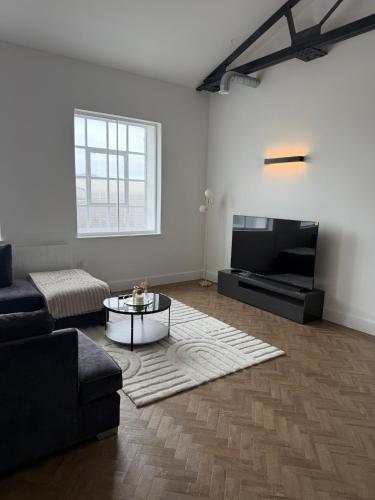 a living room with a couch and a coffee table at Cosy one bedroom flat in the heart of Chelmsford in Chelmsford