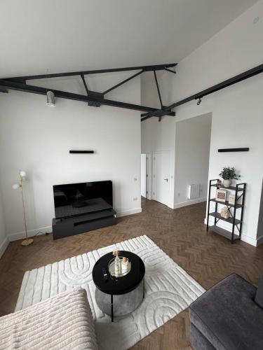 a living room with a couch and a table at Cosy one bedroom flat in the heart of Chelmsford in Chelmsford