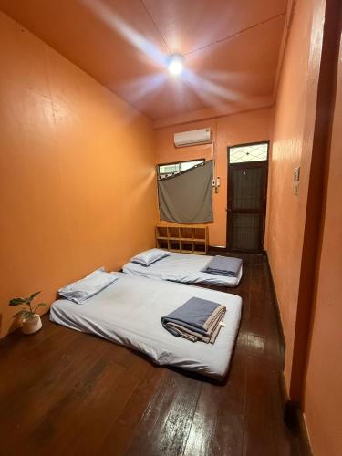 a bedroom with two beds in a small room at best 148 train staytion in Godown