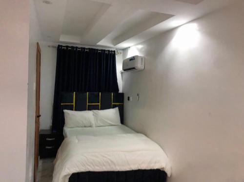 a small bedroom with a bed in a room at Debby Residence in Ijaiye