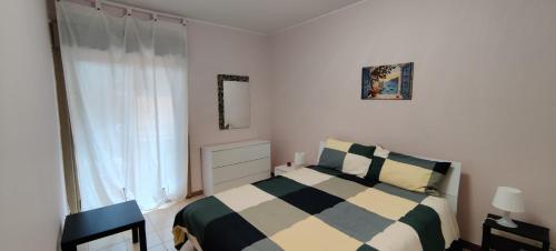 a bedroom with a black and white bed and a window at L'approdo in Schisò