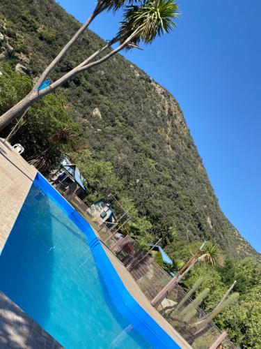 a view of a hill from a swimming pool at Cabañas del Maipo in Peumos