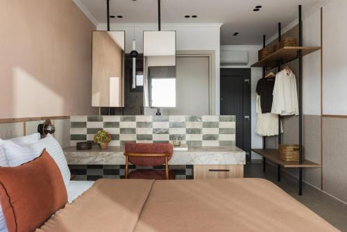 a bedroom with a bed and a kitchen at Orizon Boutique Rooms in Kalamitsi