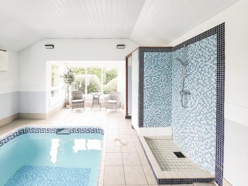 a bathroom with a swimming pool and a shower at Brompton Lodge in Ganton