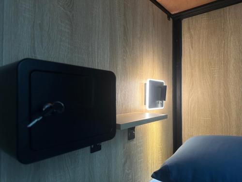 a tv on a wall next to a bed at 綠島走走 in Green Island