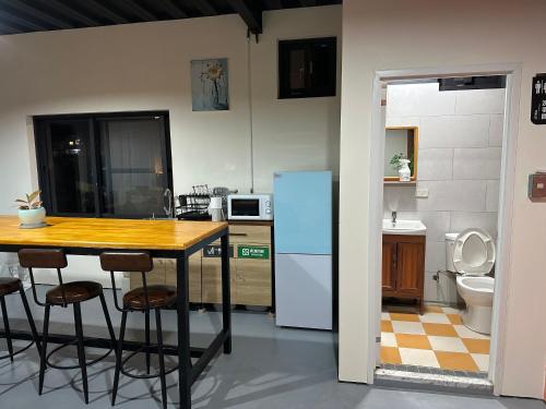 a kitchen with a table and a refrigerator at 綠島走走 in Green Island