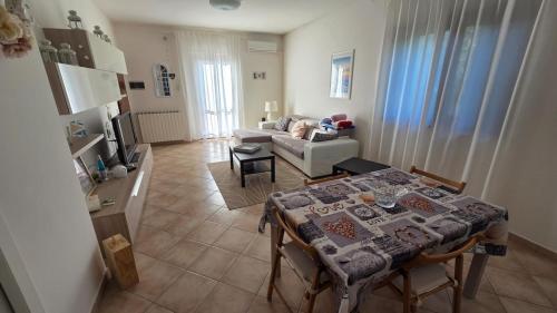 a living room with a table and a couch at Casa Adelaide - A stone's throw from Rome in Gavignano