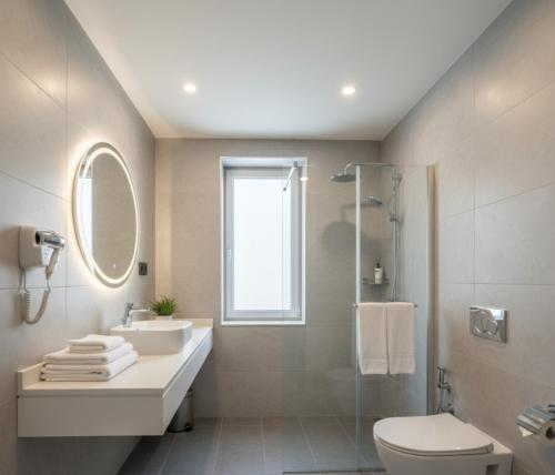 a bathroom with a sink and a toilet and a mirror at MyHome Apart Antalya in Antalya