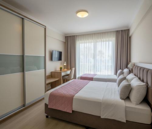 a hotel room with a bed and a window at MyHome Apart Antalya in Antalya