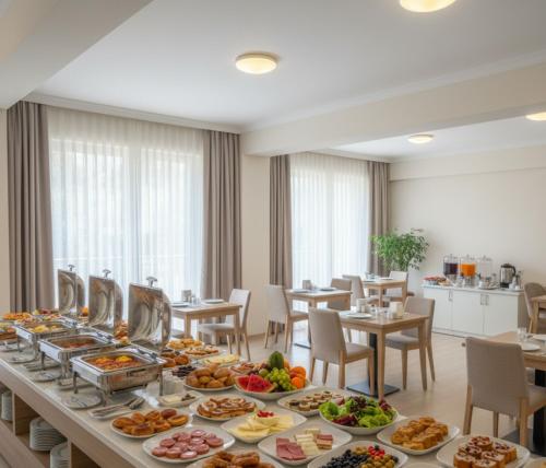 a long buffet of food on a table in a restaurant at MyHome Apart Antalya in Antalya