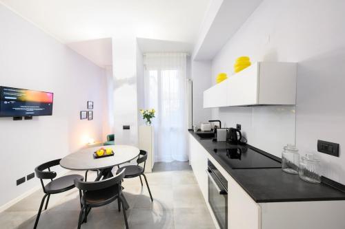 a kitchen with a table and chairs in a room at Suite Andrea-Luxury Central Suite in Bergamo
