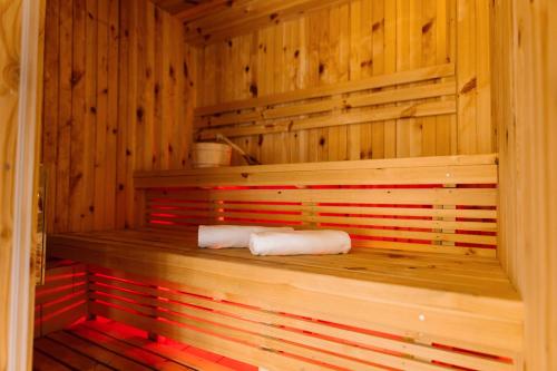 a sauna with two towels sitting on a wooden shelf at Srce Kozare in Prijedor