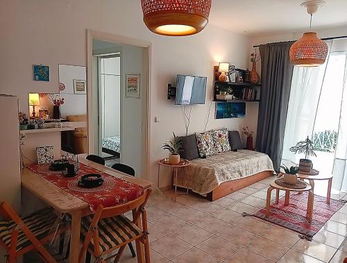 a living room with a bed and a table at Artemis sea house in Porto Rafti