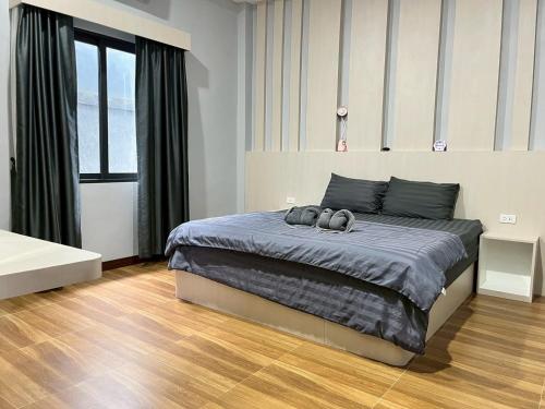 a bedroom with a bed with two pairs of shoes on it at Arun Siri Pool Villa Aonang in Ao Nang 