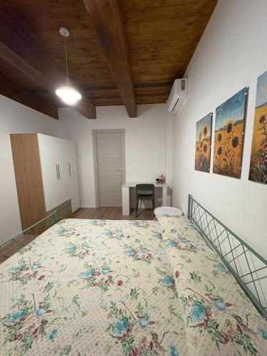 a large bed in a room with a table at B&B Fior di Feruci in Trenta