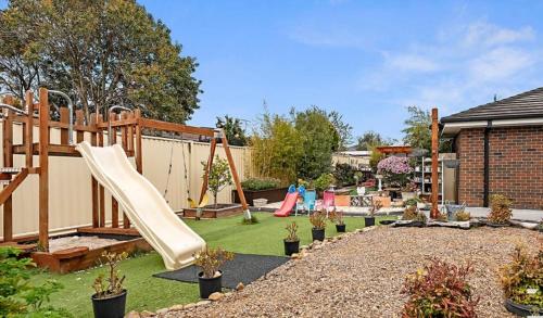 a backyard with a playground with a slide at Home of Susan Close in Narre Warren
