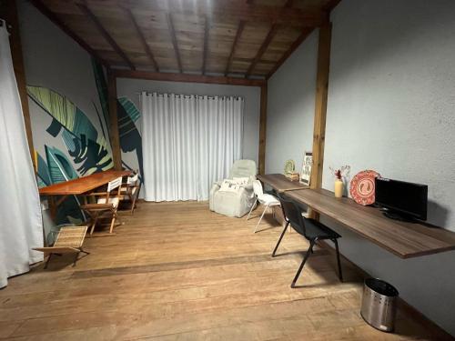 a room with a table and chairs in a room at Voila Hostel in Florianópolis