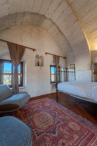 a bedroom with two beds and a rug at Valinor Cappadocia in Ürgüp