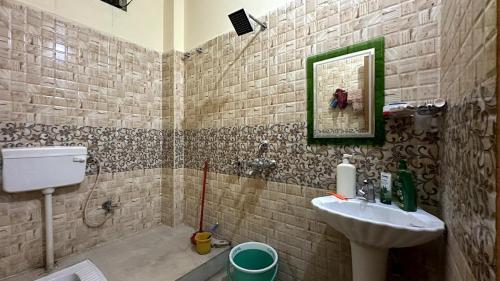 a bathroom with a sink and a mirror at Varanasi Bliss Stay in Varanasi