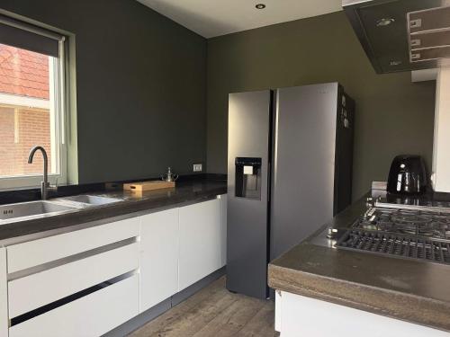 a kitchen with a refrigerator and a sink at Stylish 1-Bedroom Apartment in Eindhoven in Eindhoven