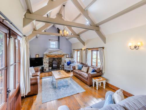 a living room with leather furniture and a fireplace at Atlantic House in Bideford
