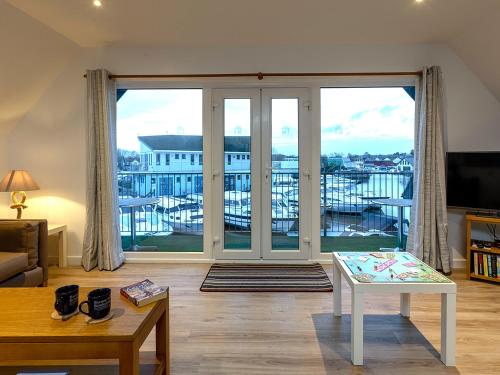 a living room with a large sliding glass door at Heron in Wroxham