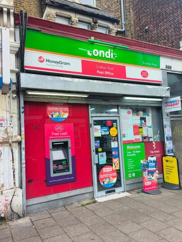 a store front with a donation machine in the window at Connell Court in London