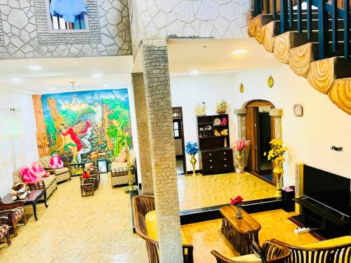 a living room with a large painting on the wall at Coastal Cloud Surf - Walk To Ahangama Beach in Ahangama