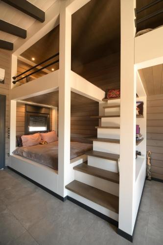 a bedroom with stairs leading up to a bed at Schinias beach villa 1 in Schinias