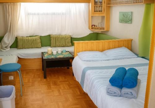 a bedroom with two beds and a table with candles at Maspalomas Pasito Blanco N in Pasito Blanco