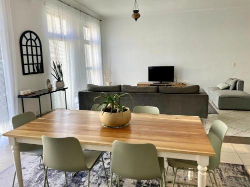 a living room with a wooden table and chairs at Surf & Stay - Muizenberg Beach in Muizenberg