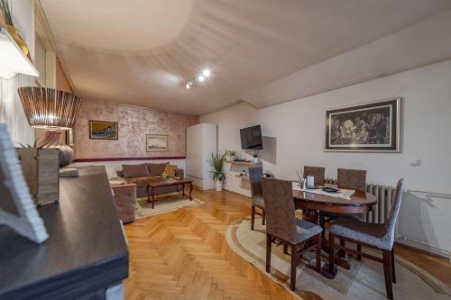 a living room with a table and a couch at Ada Home Belgrade Apartment 