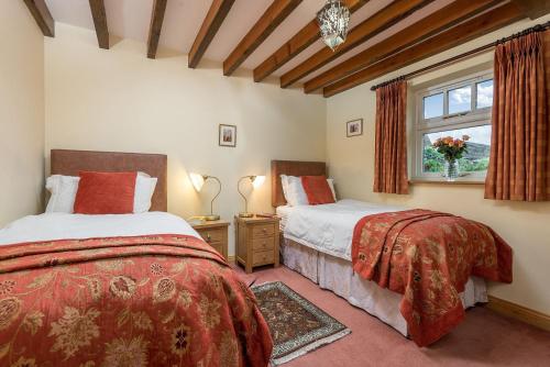 a bedroom with two beds and a window at Stables 2 bedrooms in Beverley
