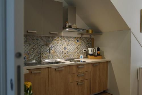 a small kitchen with a sink and a stove at Nicuzza in Gela