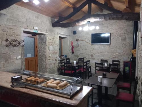 een restaurant met een toonbank met wat brood erop bij Albergues O Abrigo Miraz 