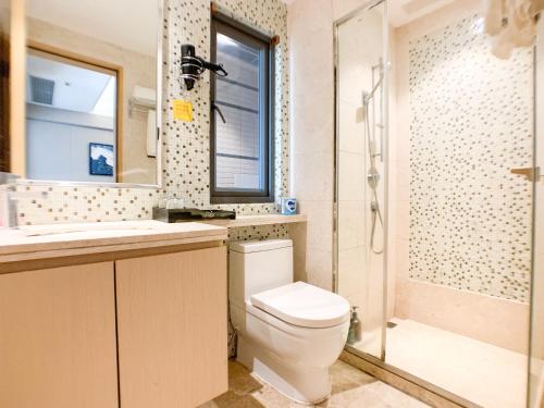 a bathroom with a toilet and a shower at Hesheng Hotel Apartment in Shenzhen