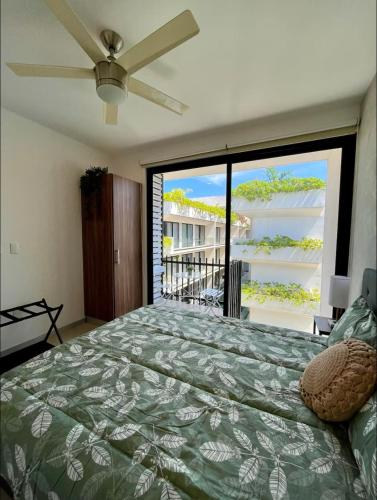 a bedroom with a bed and a large window at Casa Xaman-Ha At Urban Towers in Playa del Carmen