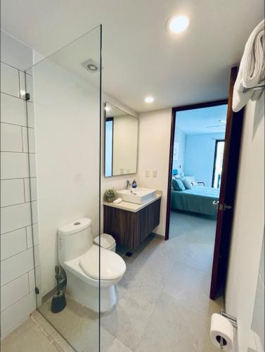 a bathroom with a toilet and a sink at Casa Xaman-Ha At Urban Towers in Playa del Carmen