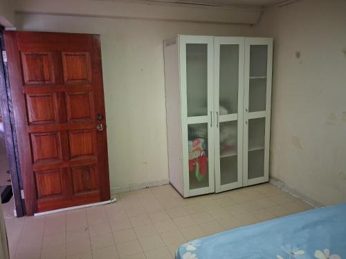 a bedroom with an open door and a closet at Fortune Room Stay 3 in Sandakan