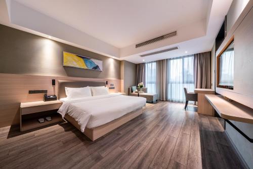 een hotelkamer met een bed en een televisie bij Shengfeng Mingzuo Hotel in Hangzhou