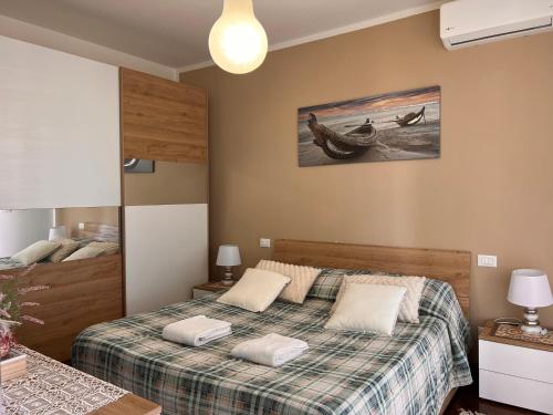 a bedroom with a bed and a boat on the wall at Casa BELLOCCHIO in Perugia