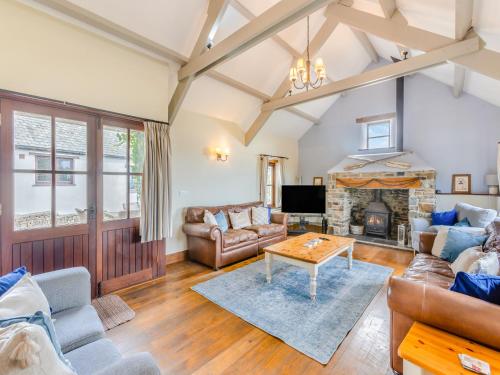 a living room with couches and a fireplace at Atlantic House in Bideford