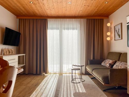 a living room with a couch and a window at Aparthaus Bianca in Gaschurn