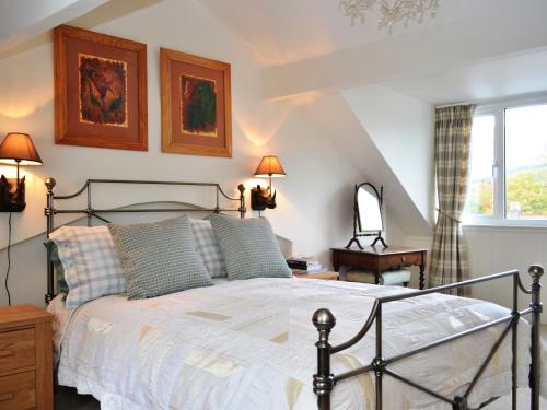 a bedroom with a bed and a window at Catbells Cottage Keswick in Keswick