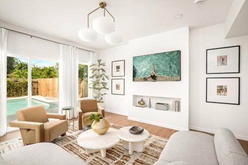 a living room with a couch and a table at Downtown 7 min, 27 sleeps, Gated 2 homes, Accessible in Houston