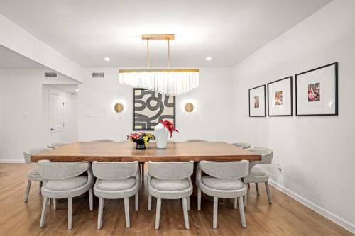 a dining room with a wooden table and chairs at Downtown 7 min, 27 sleeps, Gated 2 homes, Accessible in Houston