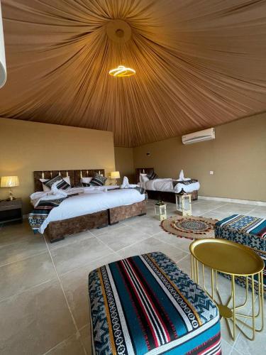 a bedroom with a large bed with a ceiling at Wadi Rum Bubbles Luxury Camp in Wadi Rum